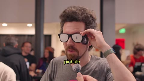 Source frame at 40.500s. Traffic light, colored laptop grid, improvised glasses.