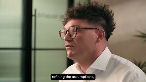 Source frame at 60.500s. Alternating interview angles, then white wordmark card.